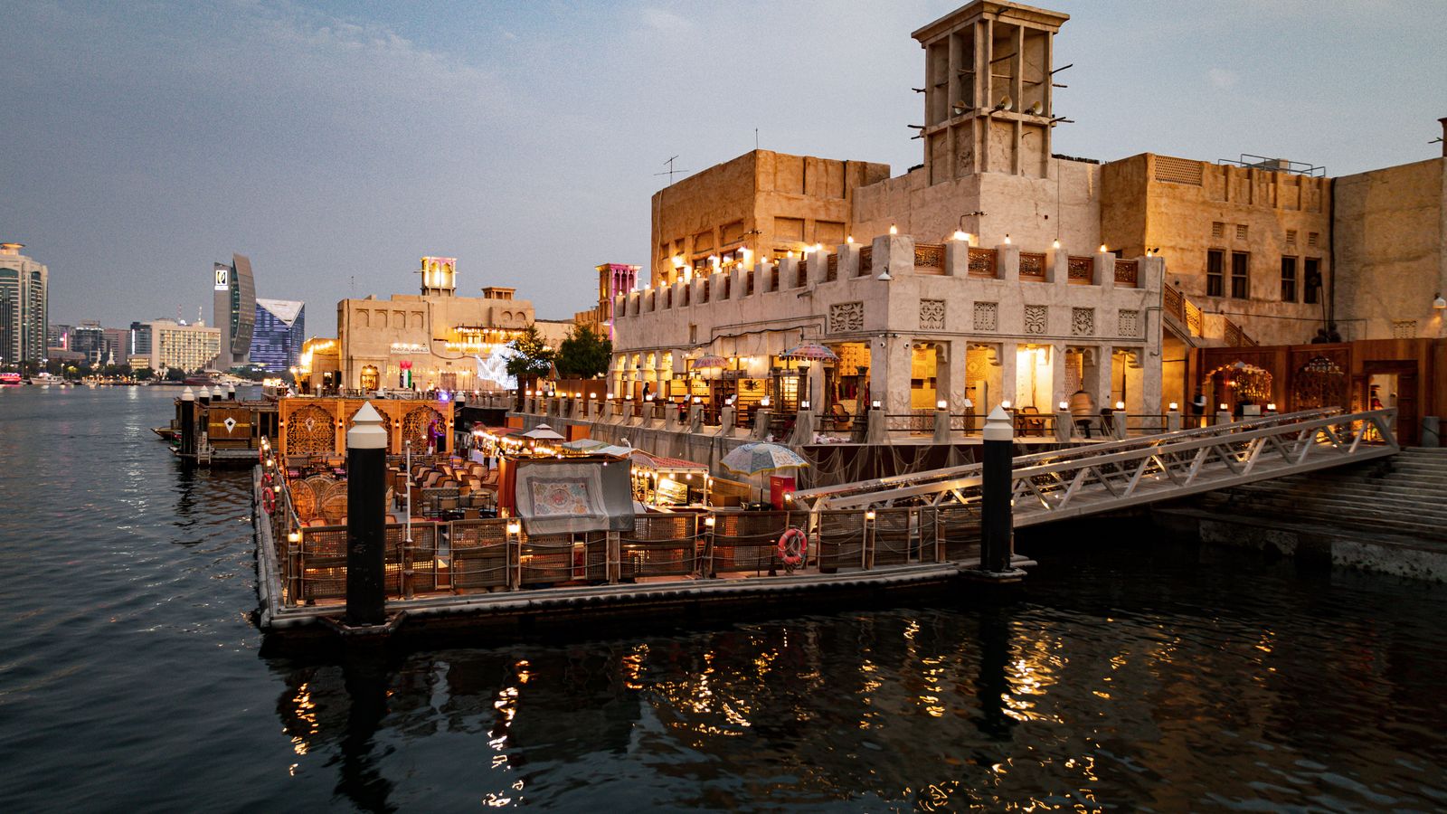 Traditional buildings by the Dubai Creek waterfront at dusk