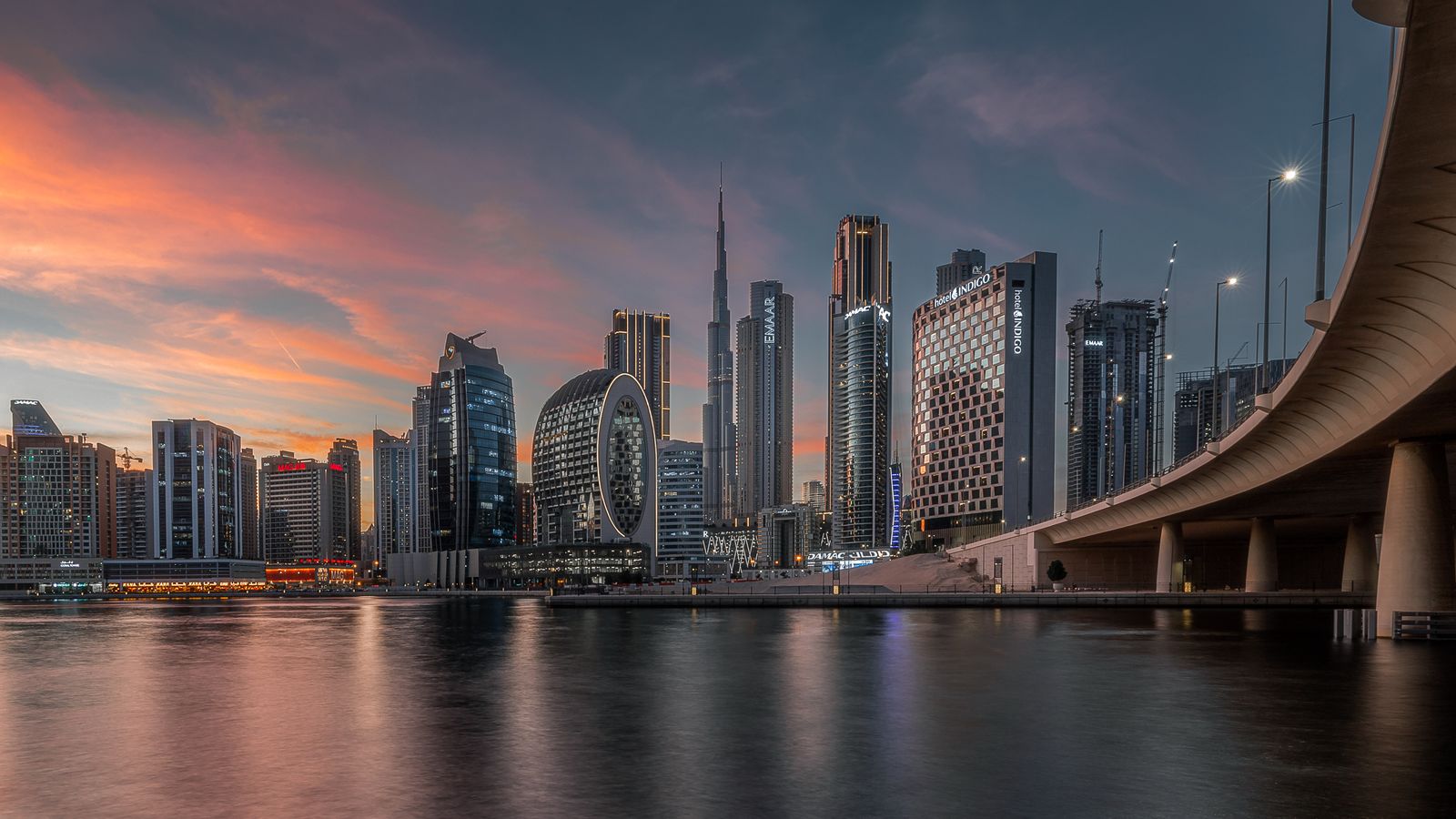 Dubai Business Bay skyline reflected in the canal at sunset